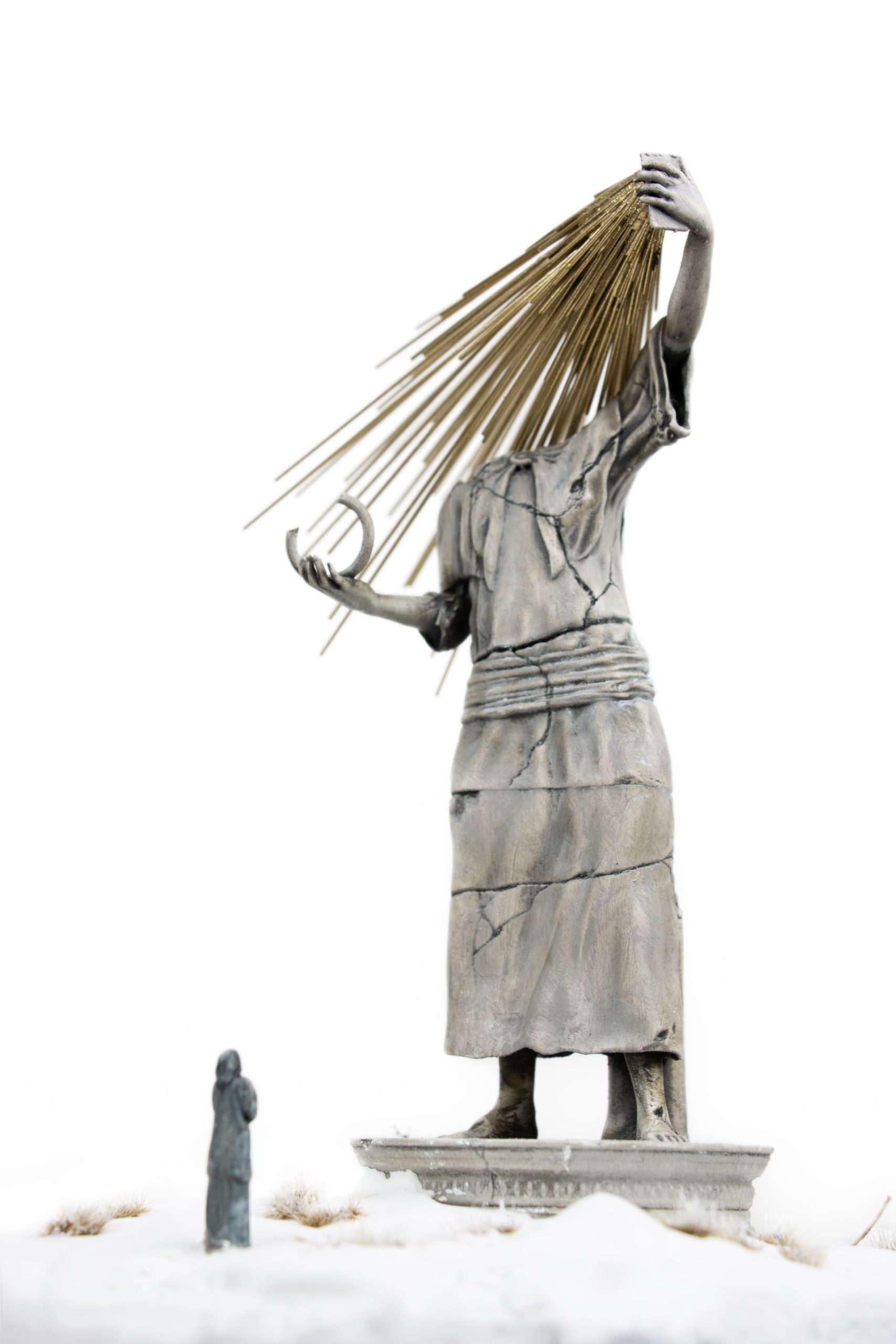 a miniature person looking at a figurative statue whose face melds into a phone