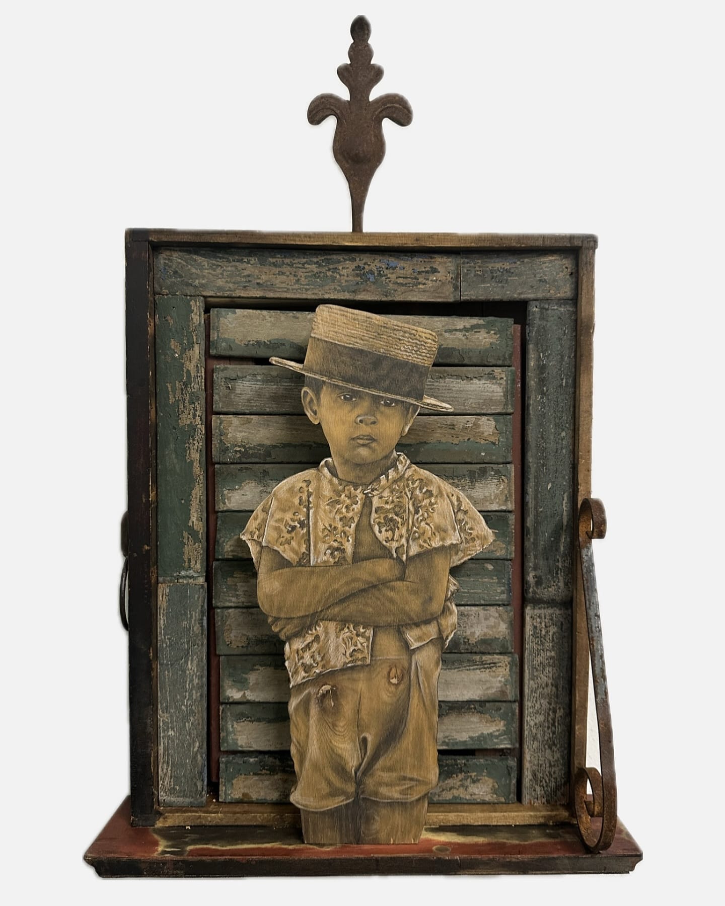 a portrait of a young boy in a hat on found wood