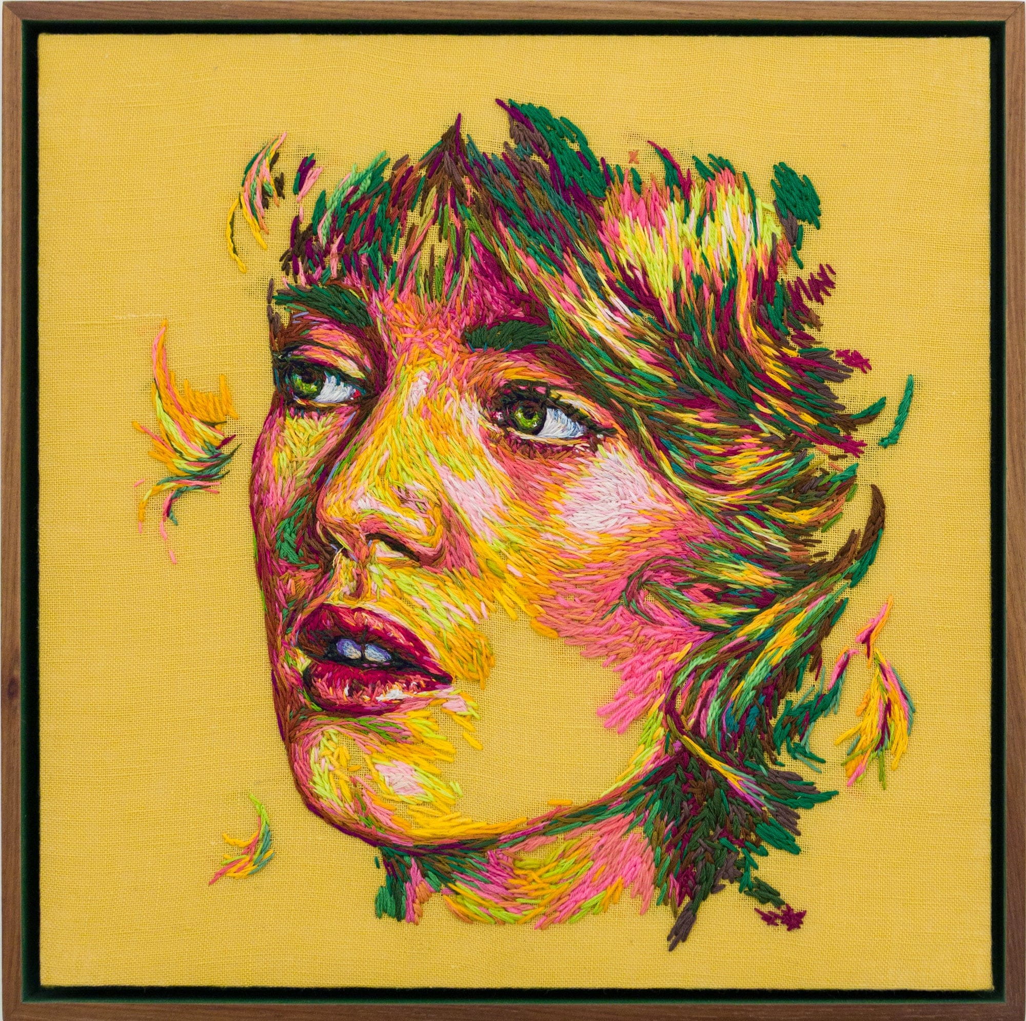 a crewel embroidery composition by Danielle Clough of a woman's face on a yellow background