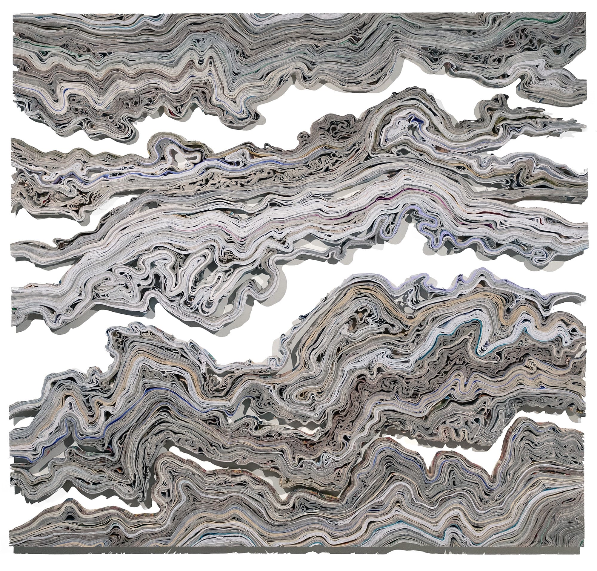 an abstract wall artwork by Jessica Drenk using repurposed junk mail in curving forms