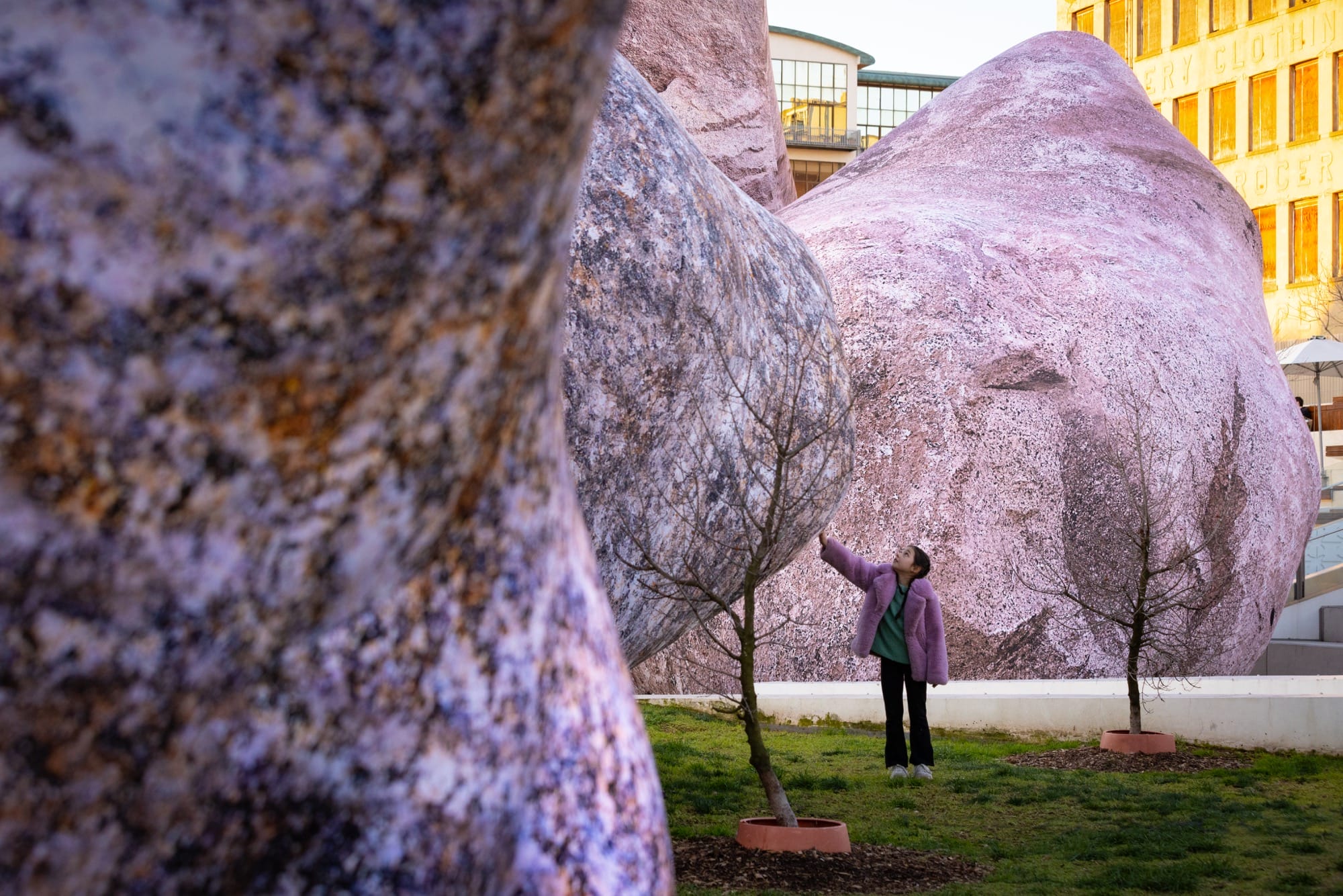 a person touches a massive inflatable rock