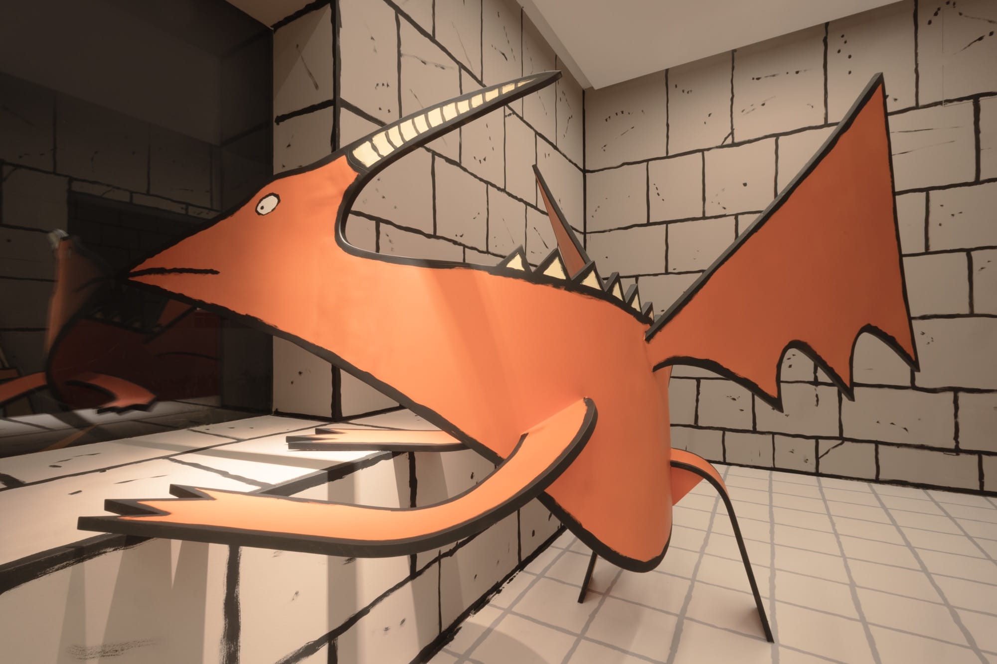 an orange drawn sculpture peeking in a window