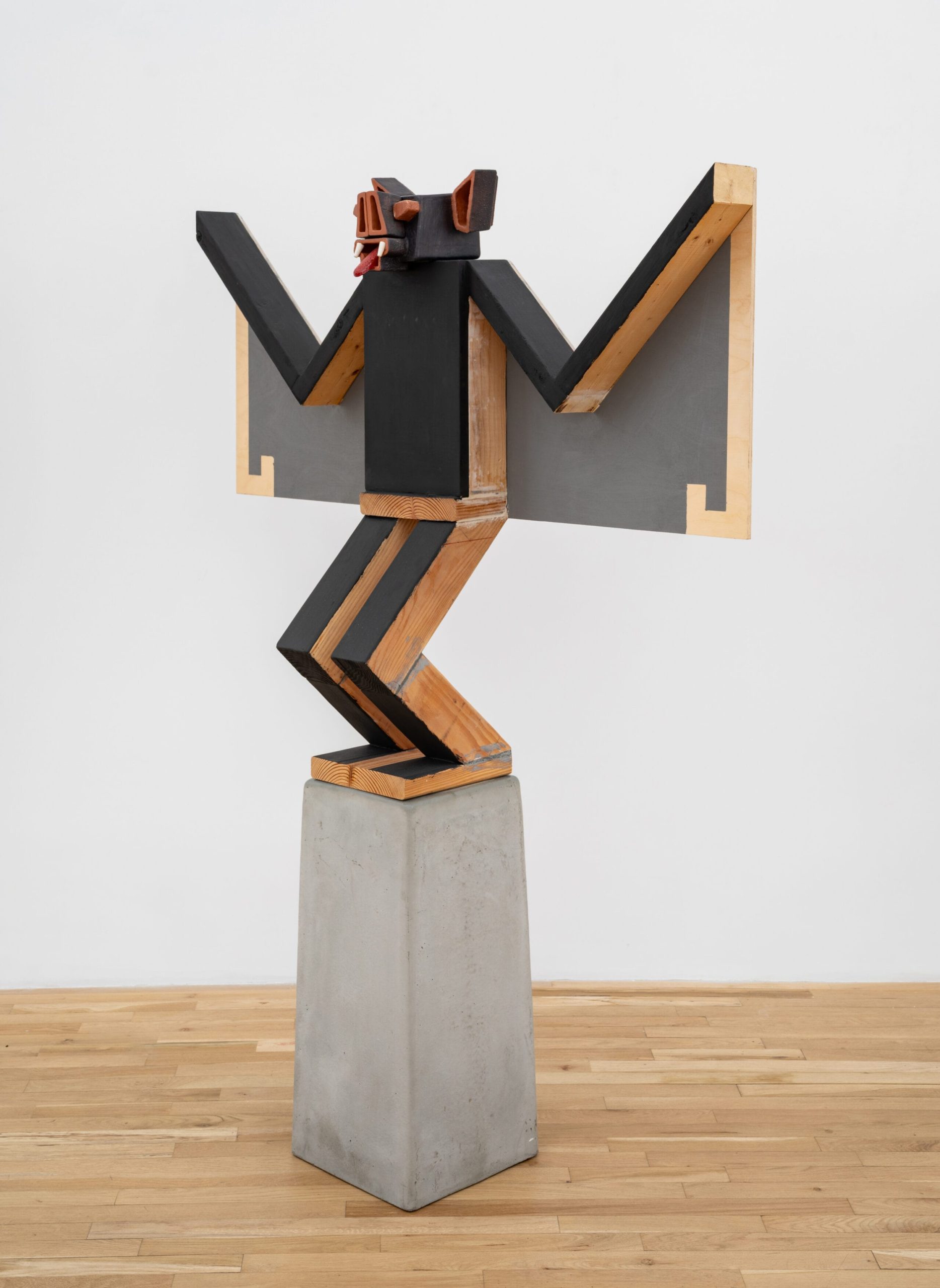 a sculpture by Steve Keister of a blocky, cartoonish bat on a pedestal
