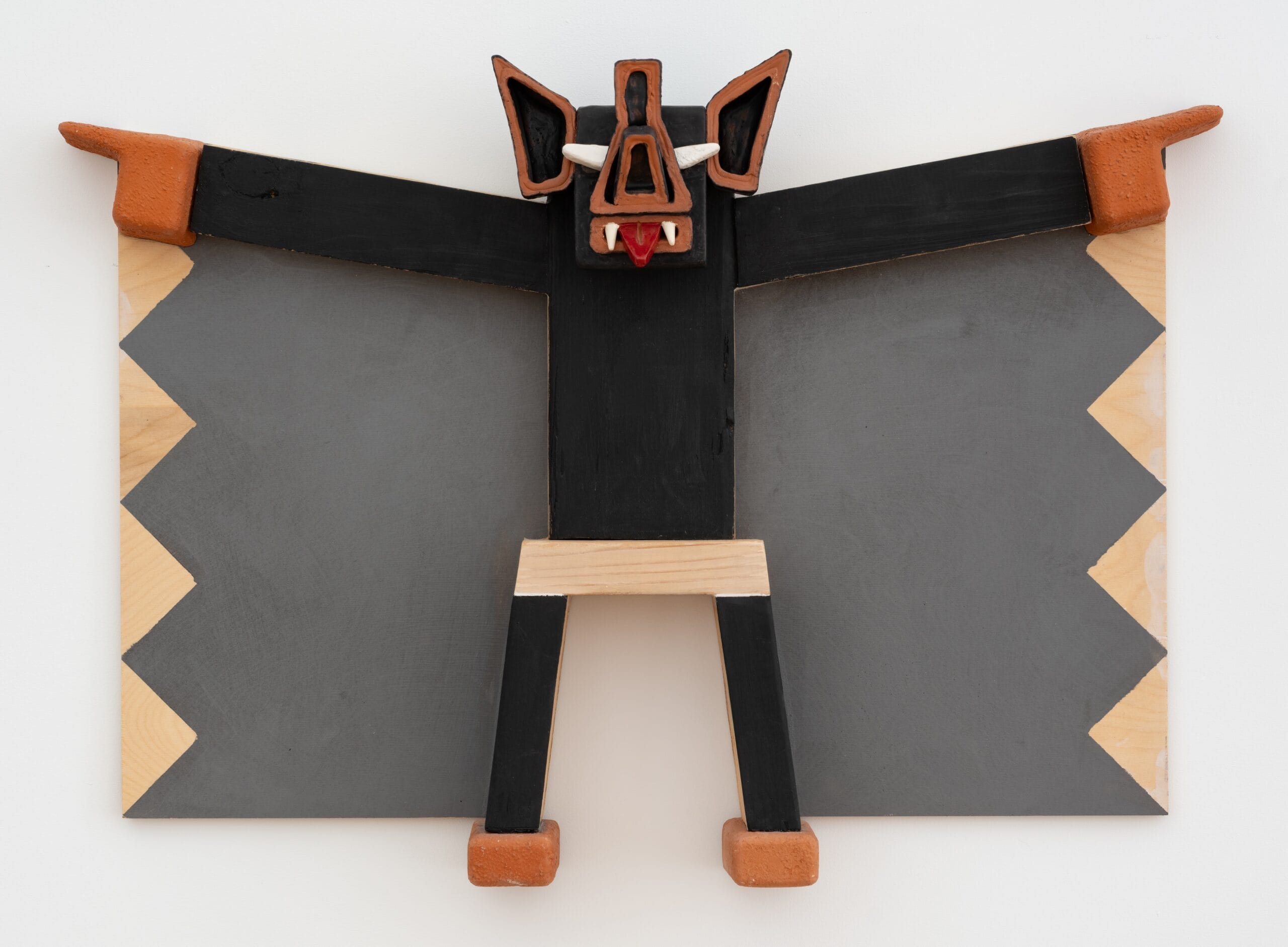 a wall relief painting by Steve Keister of a blocky, cartoonish bat