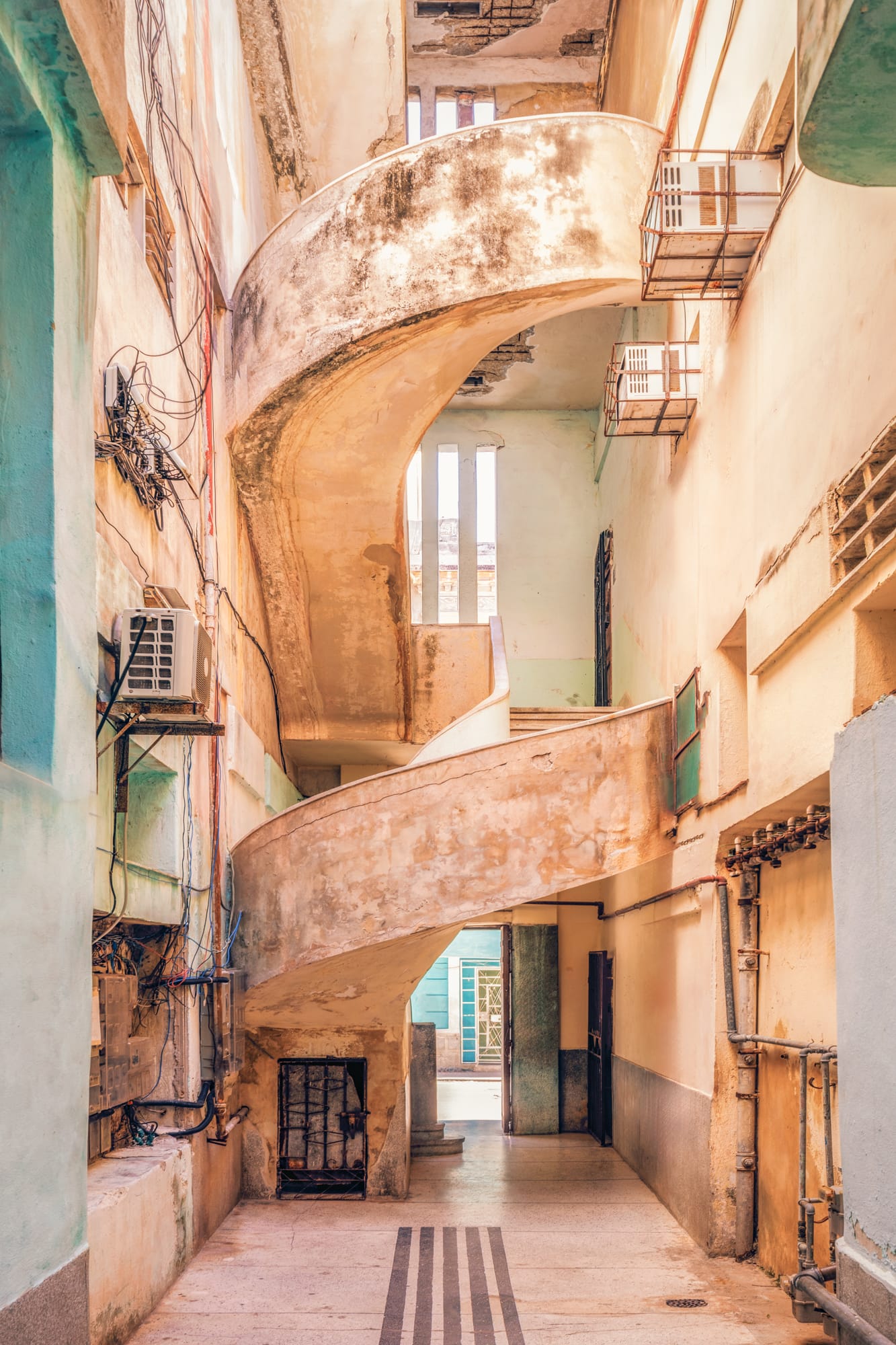 a photograph by James Kerwin of a large, ornate stairwell in a courtyard in Cuba