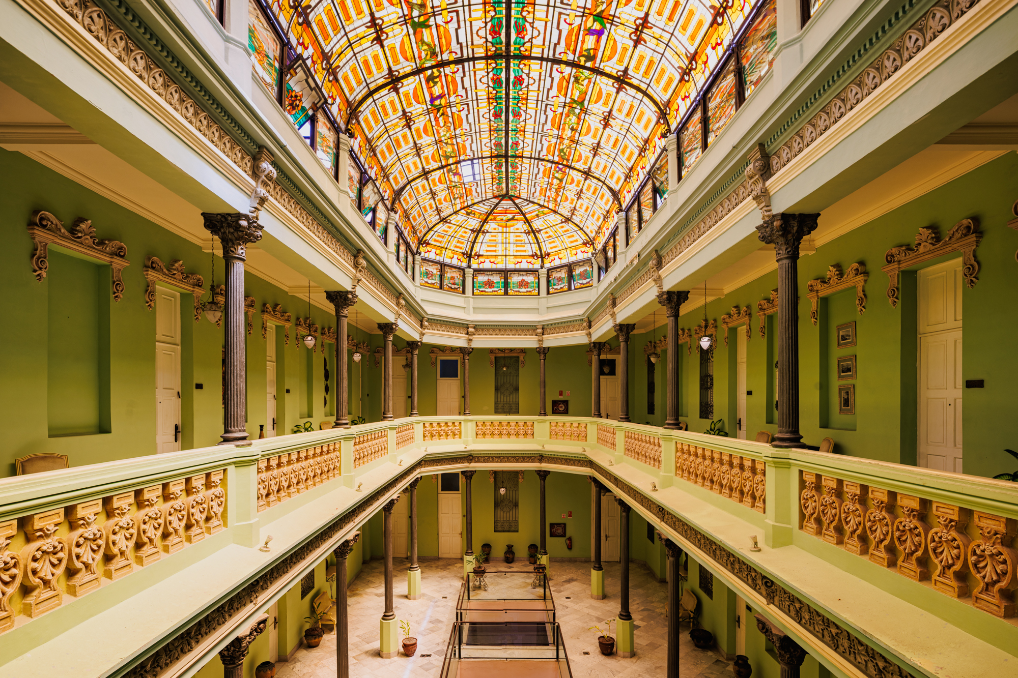 a photograph by James Kerwin of a dilapidated Victorian-style arcade and mezzanine in Cuba