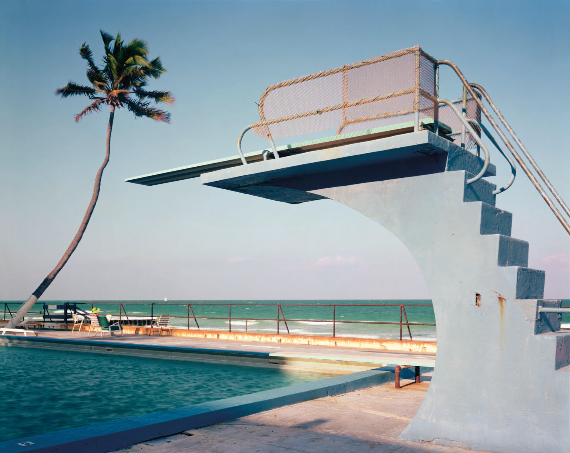 A photo by Joel Meyerowitz of a diving board and swimming pool in Florida in 1978