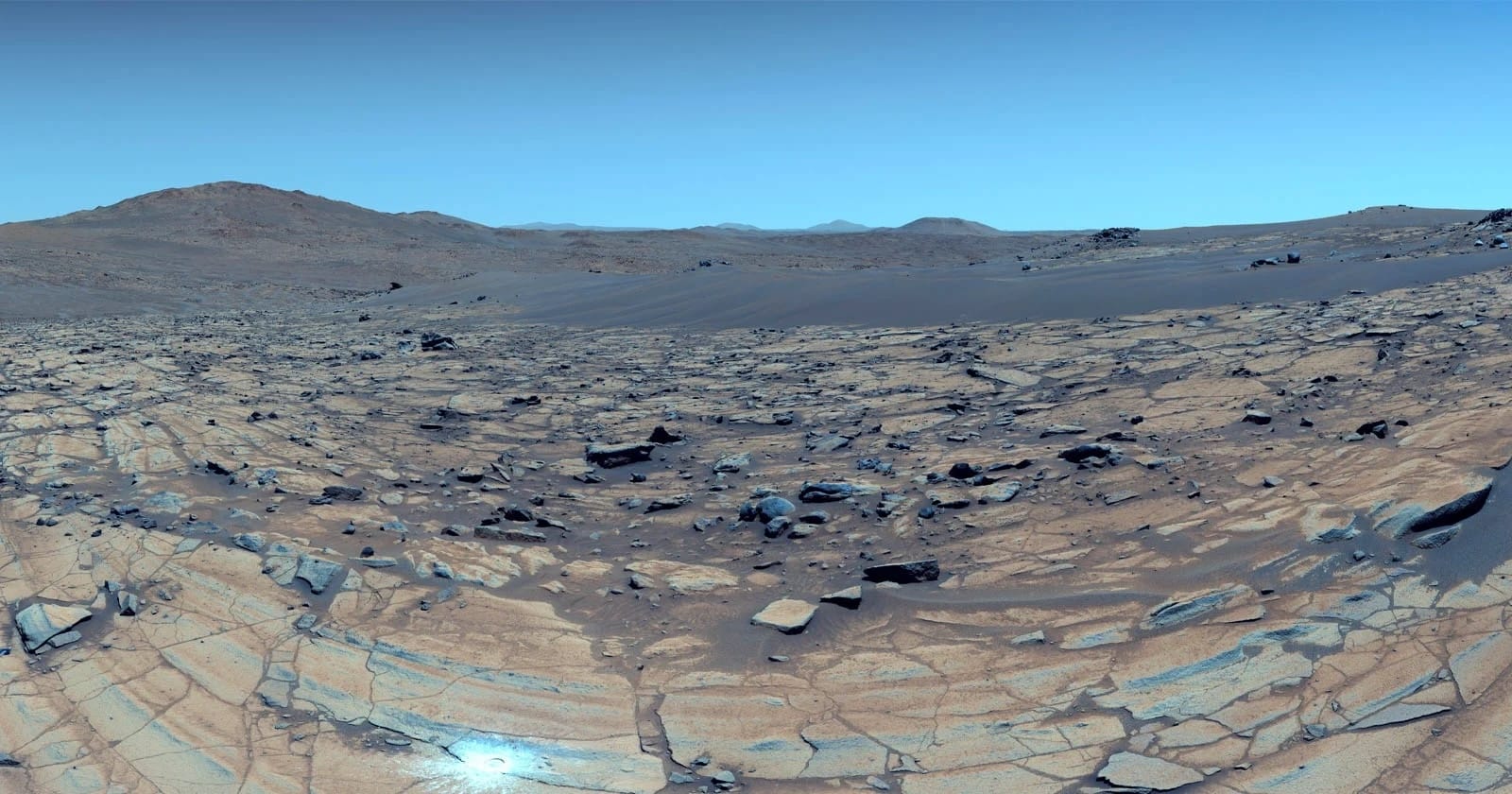 a color-enhanced photo of a Martian landscape that makes the red planet look more Earth-like