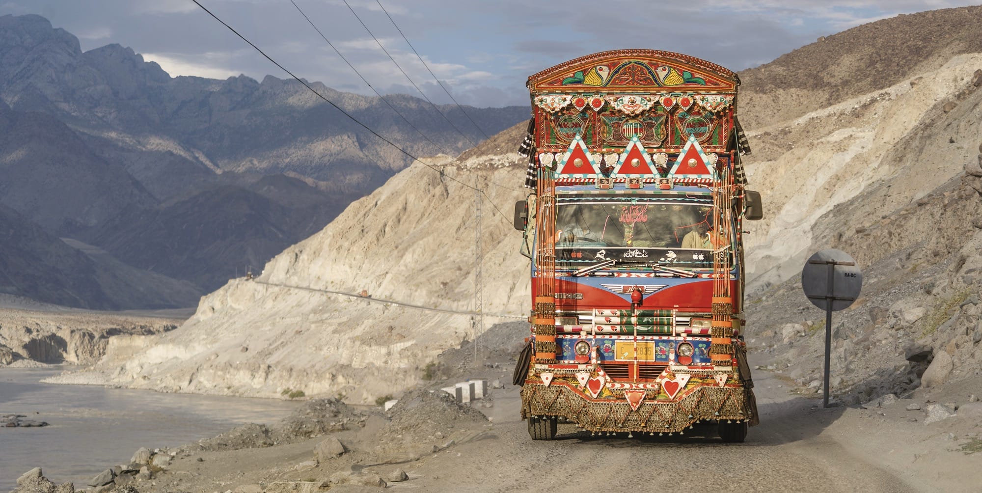 a colorfully painted truck on a mountainous pass
