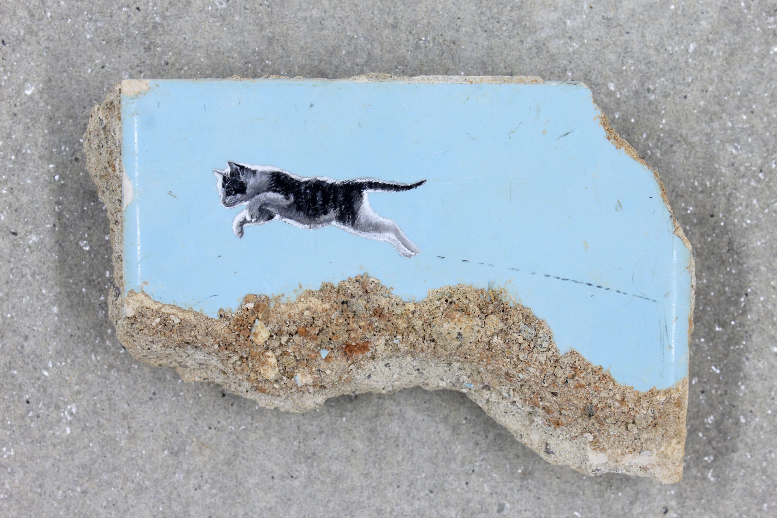 a painting of a cat leaping on a fragment of blue tile by William Mophos
