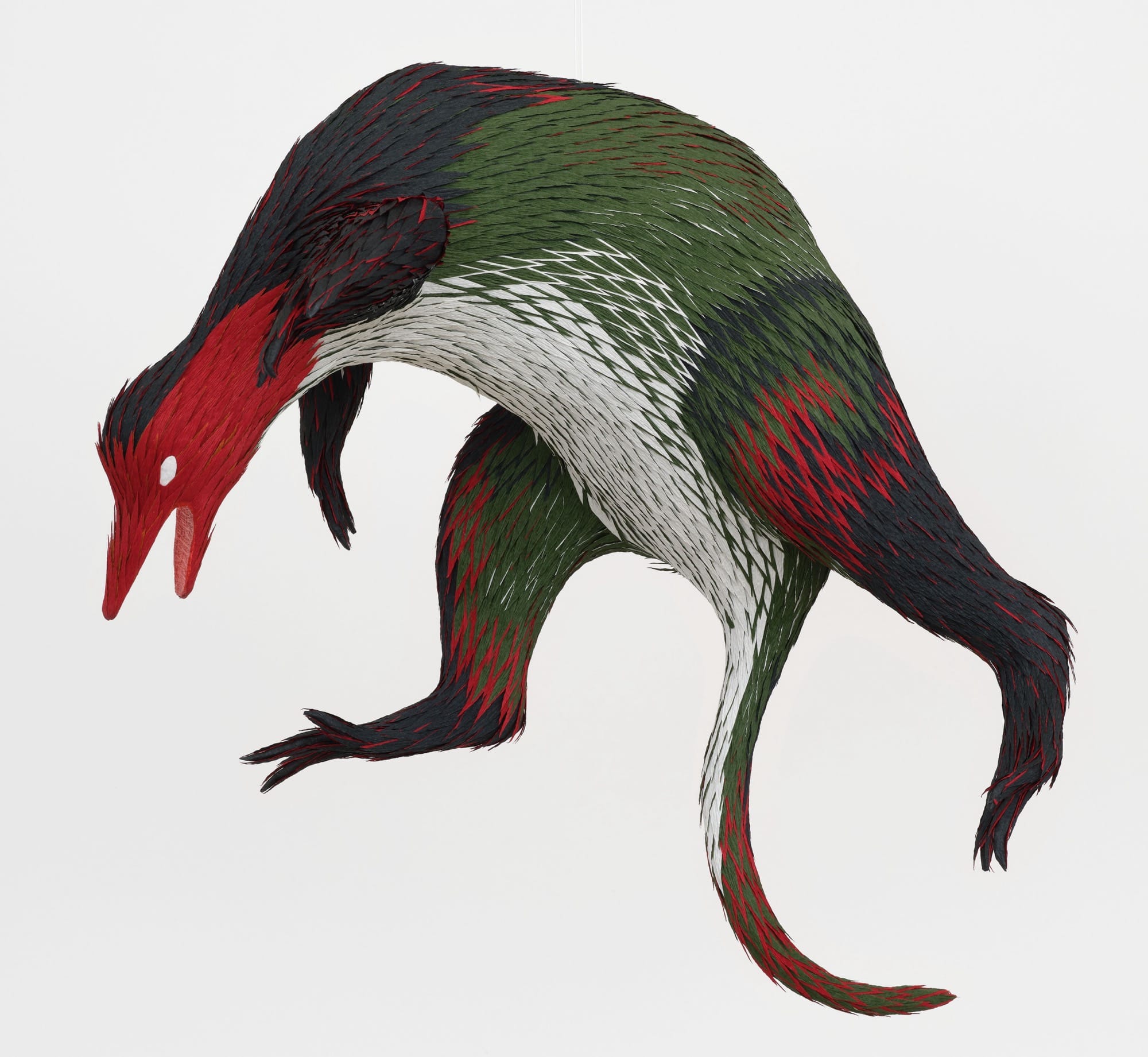 a papier-mâché sculpture by Roberto Benavidez of an imaginary green and red creature based on a detail of a Hieronymus Bosch painting