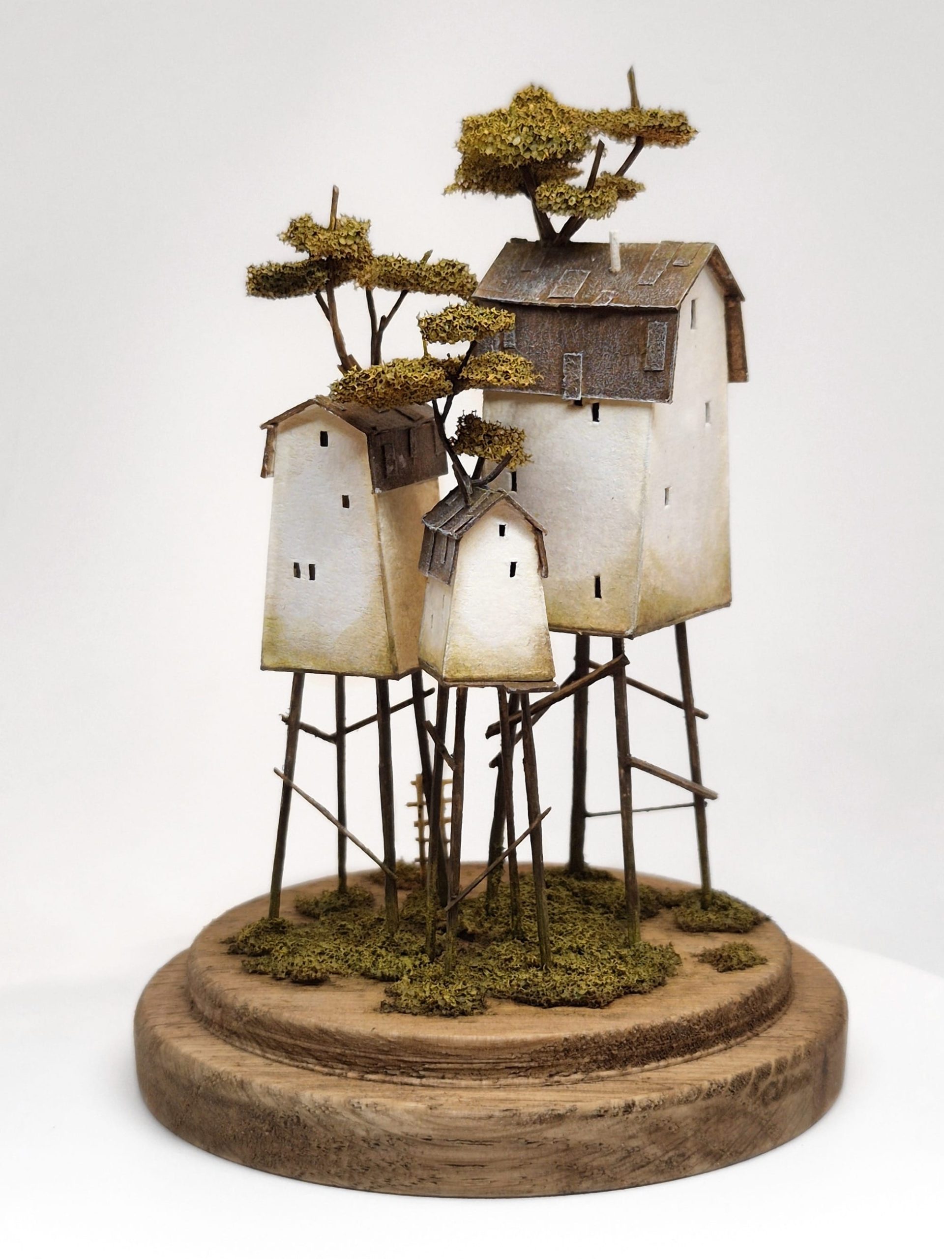 a miniature sculpture by Michael Davydov of a stack of tiny houses