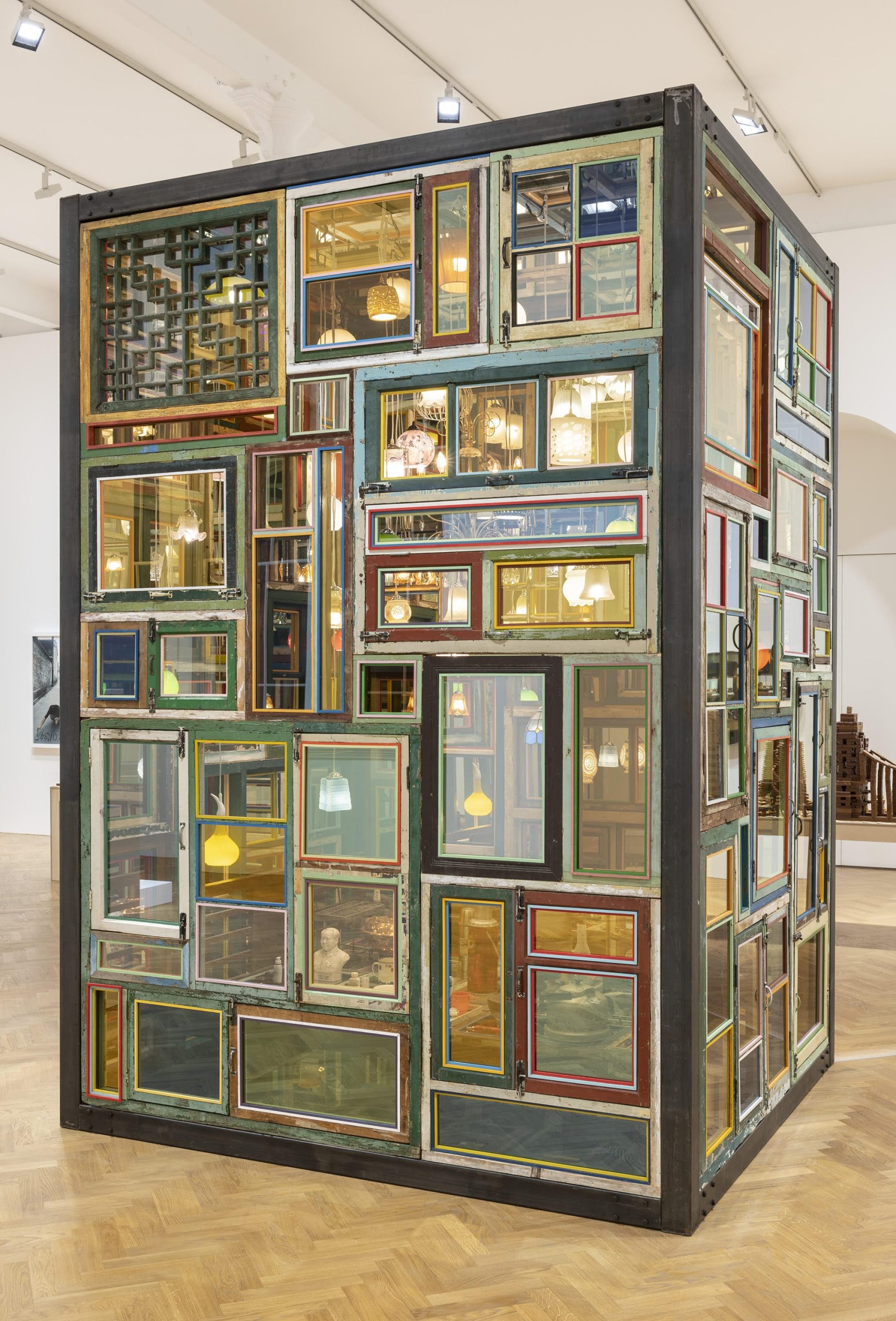 an installation by Song Dong using found wooden window frames and color-coated glass