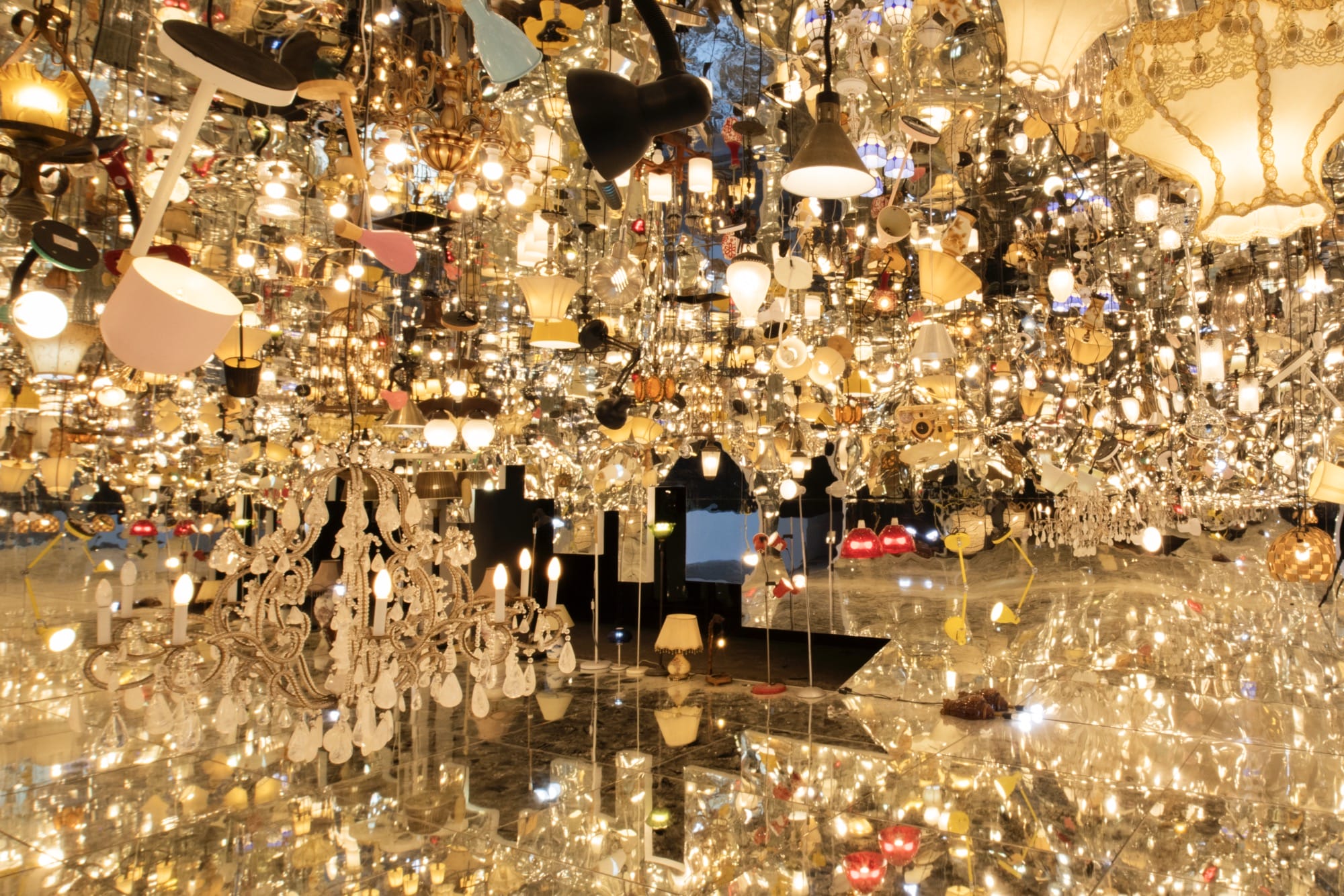 an installation by Song Dong made from borrowed furniture, lamps, and reflective surfaces