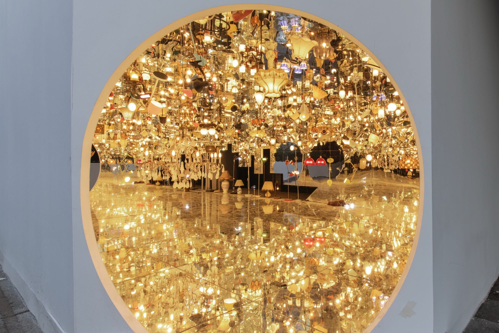 an installation by Song Dong made from borrowed furniture, lamps, and reflective surfaces