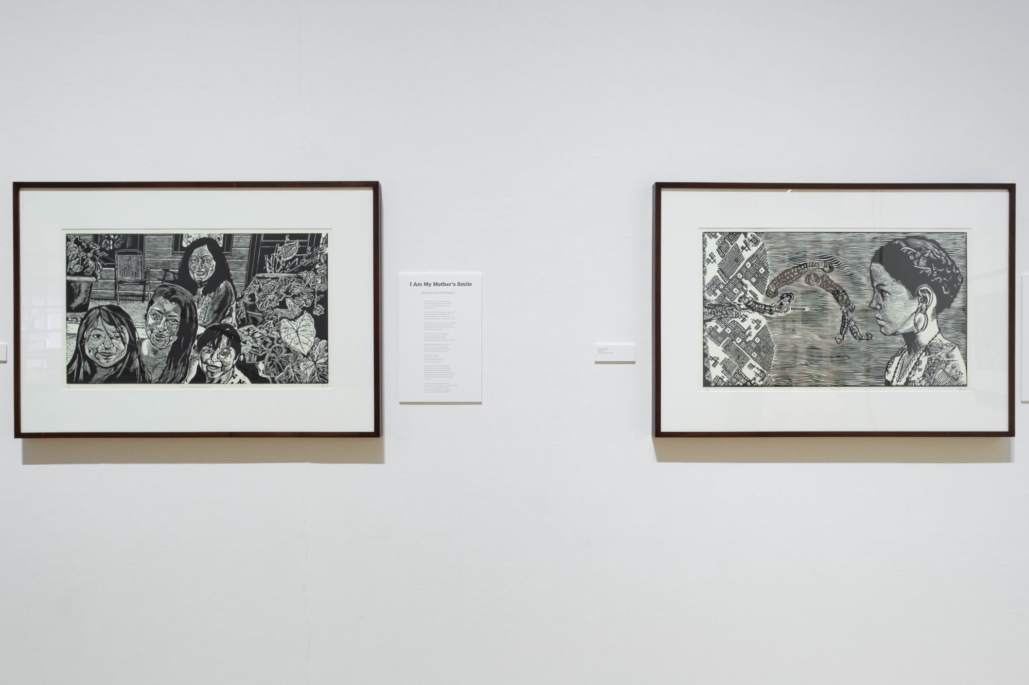 two framed woodcut portraits by Raoul Deal in a gallery at the Haggerty Museum of Art