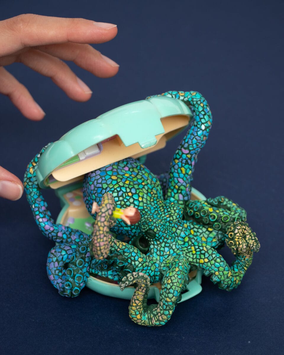 a sculpture by Stéphanie Kilgast of a colorful octopus inside of a Polly Pocket toy