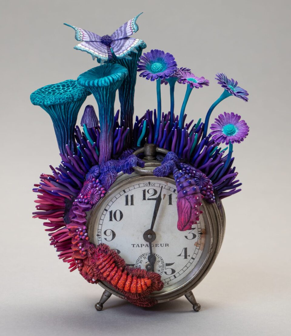 a sculpture by Stéphanie Kilgast of colorful mushrooms growing out of an alarm clock