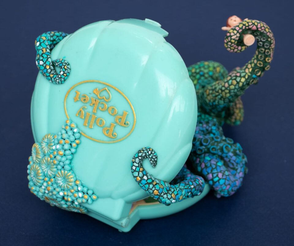 a sculpture by Stéphanie Kilgast of a colorful octopus inside of a Polly Pocket toy