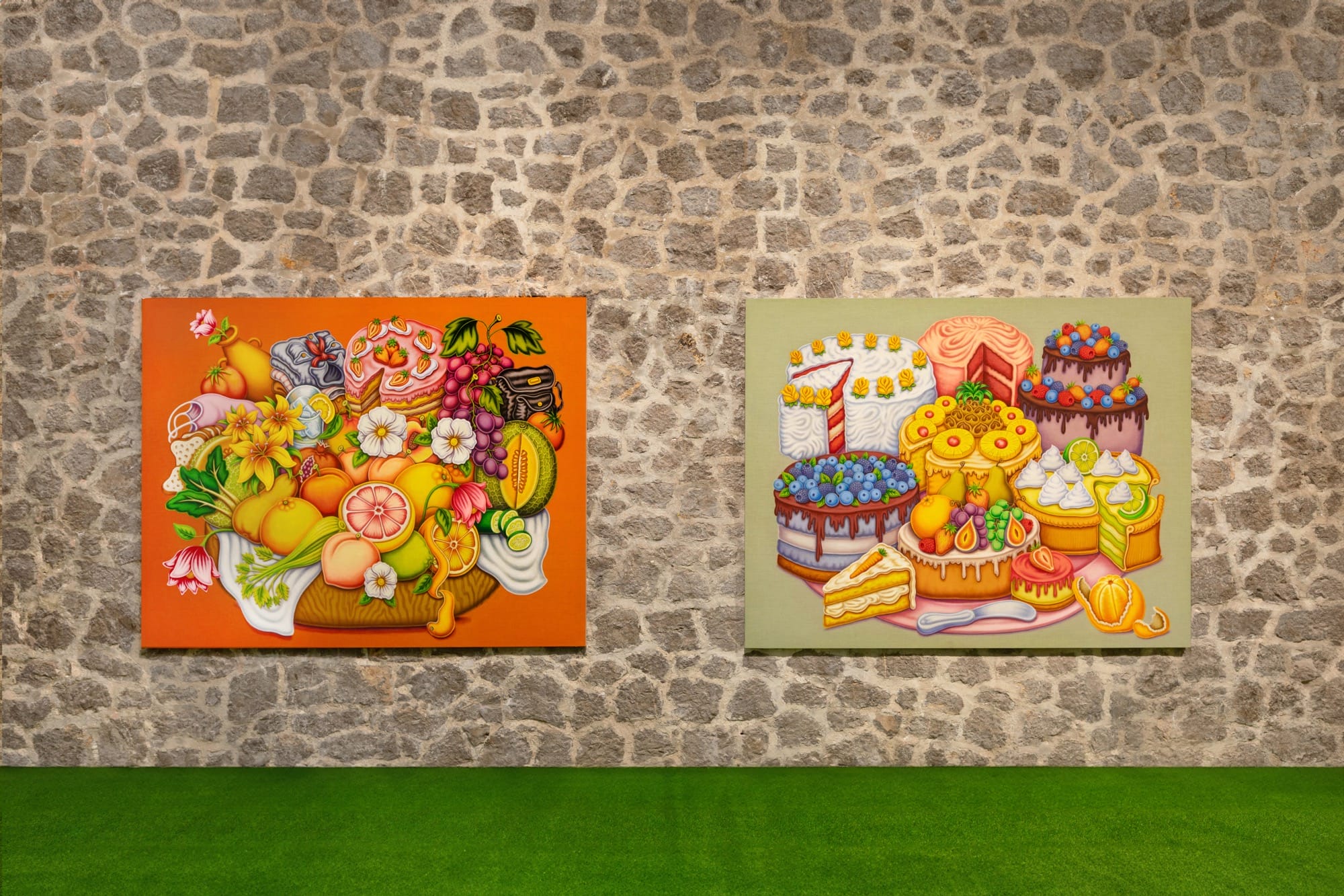 two paintings by Pedro Pedro of numerous fruits and treats, installed on a stone wall