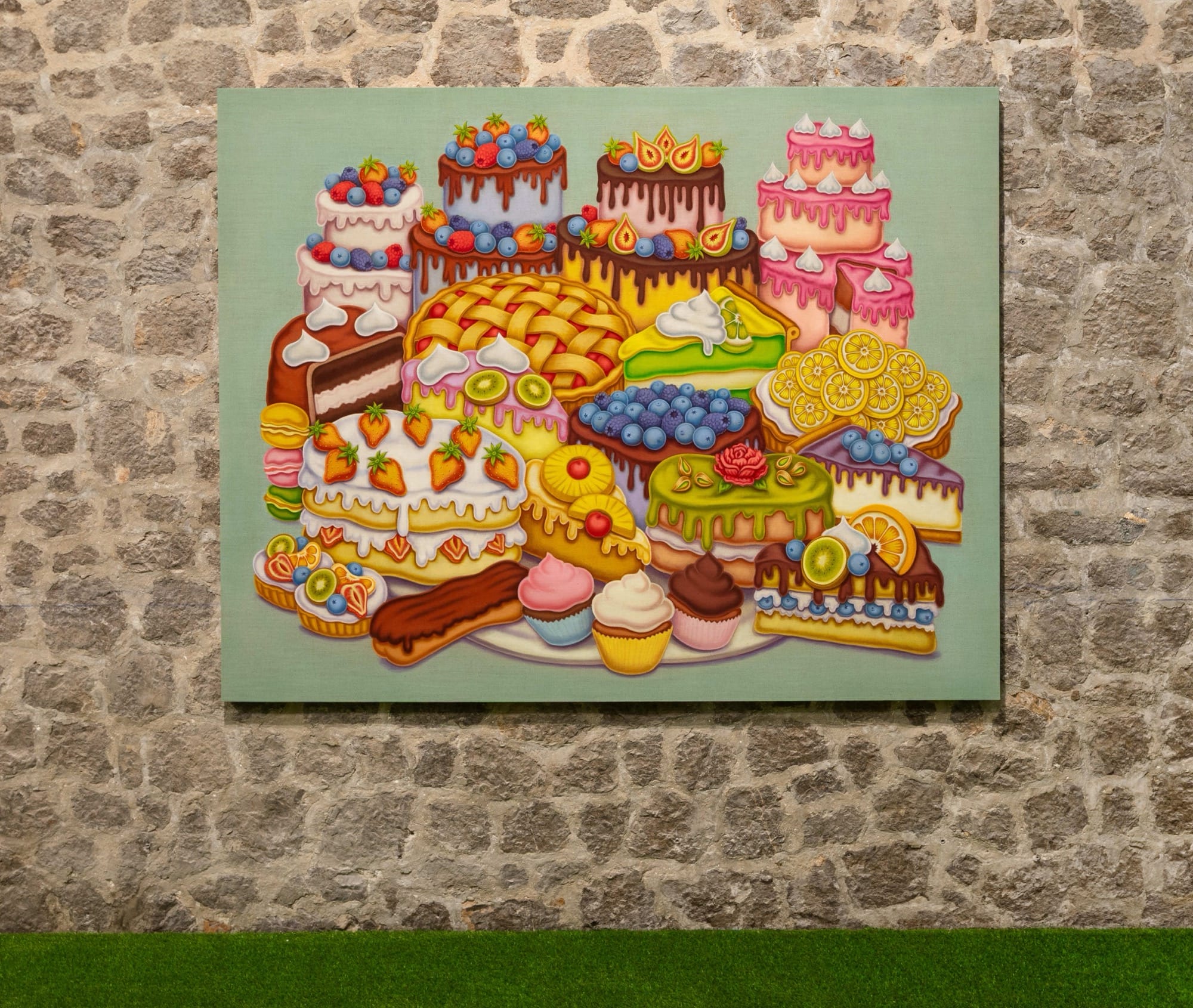 a painting by Pedro Pedro of numerous fruits and treats, installed on a stone wall