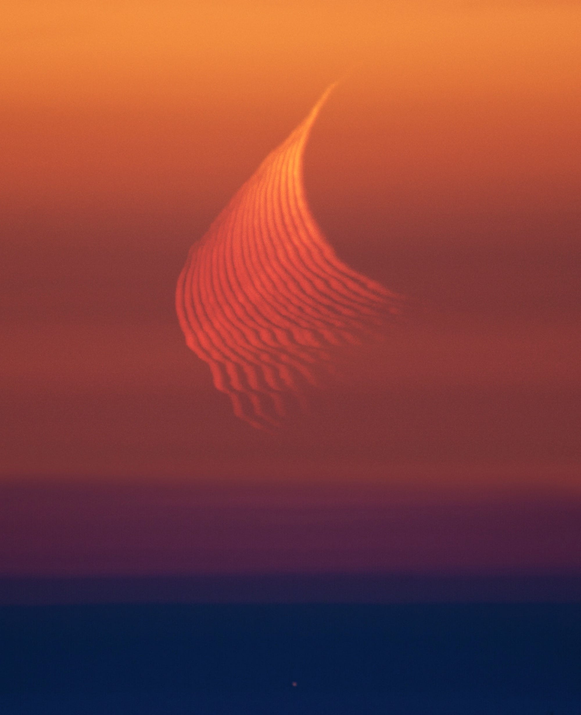 a photo of refractive light from the moon in a dusky sky
