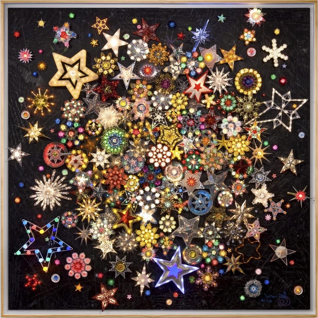 a square composition by Carlos Betancourt featuring numerous stars and sparkle-like shapes against a black background