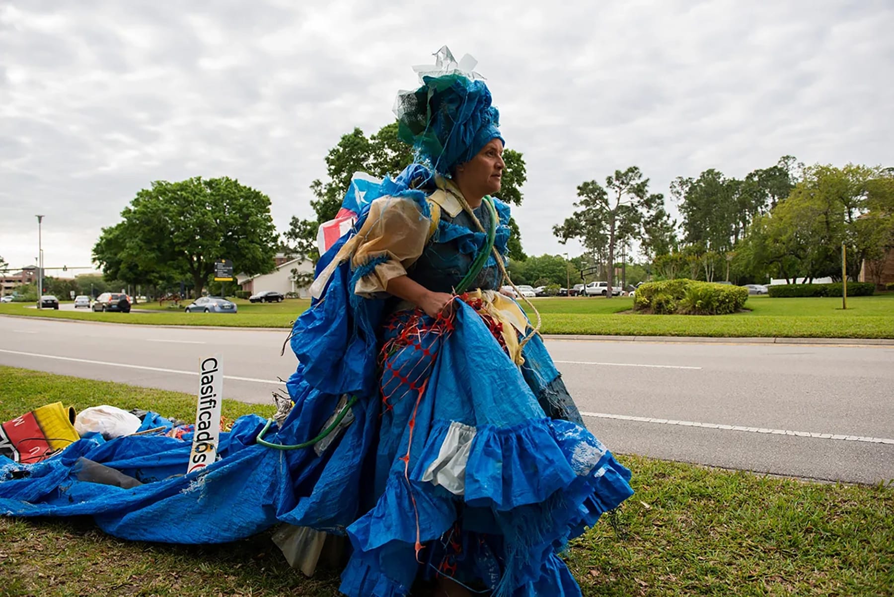 a photograph of Wanda Raimundi-Ortiz in an elaborate costume made of blue tarps and other plastics